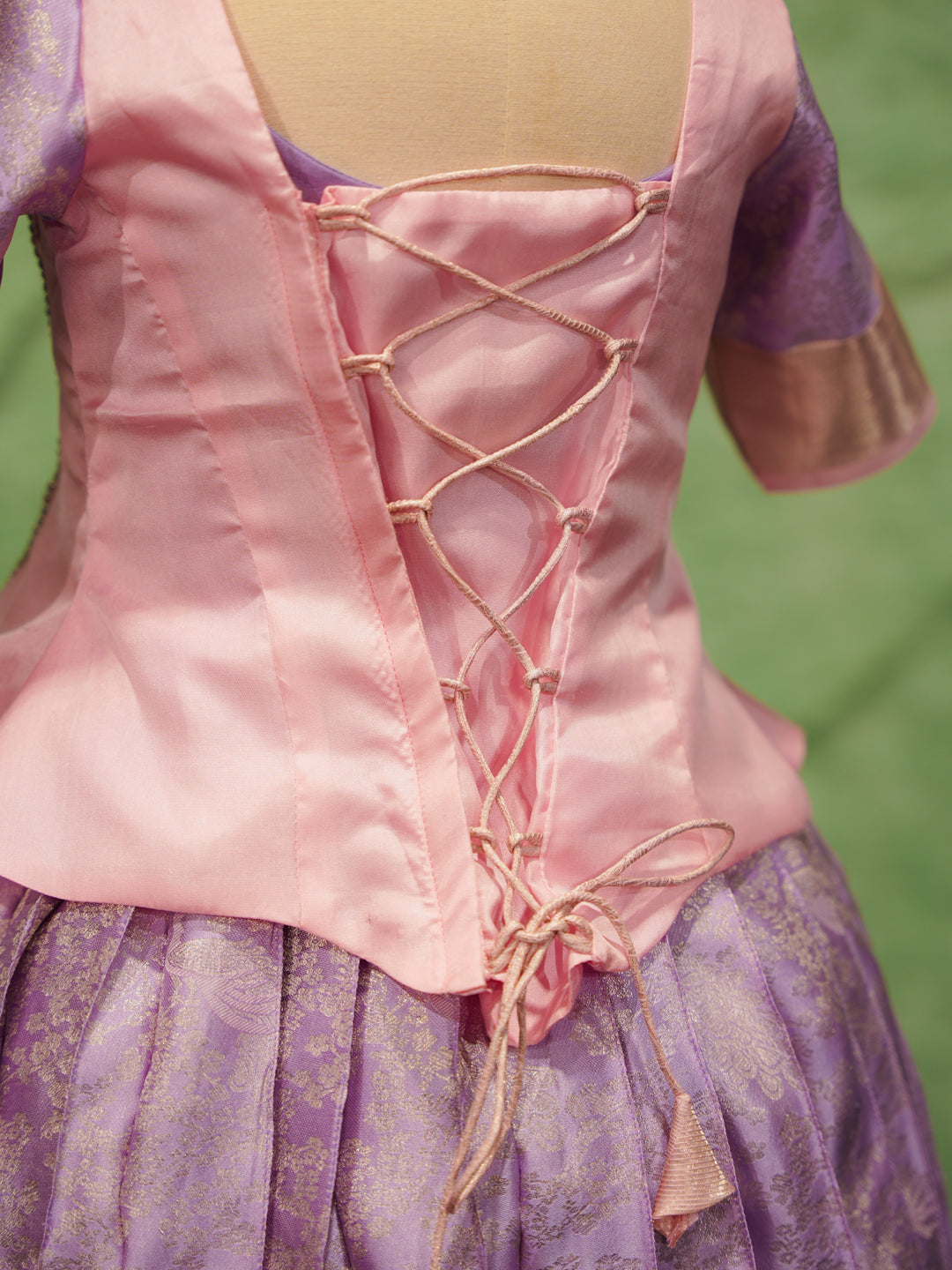 Lavender and pink pattu pavadai in pure Kanchipuram silk with zari border and beaded neckline — back view
