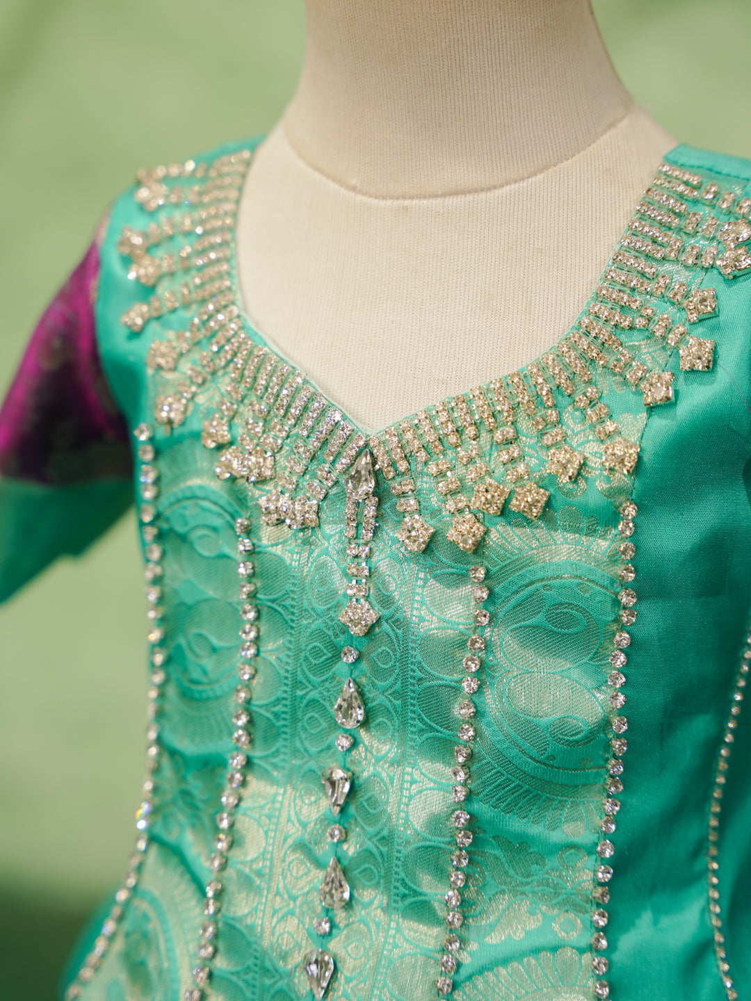 Mint and purple pattu pavadai in pure Kanchipuram silk with embellished blouse and zari skirt — neckline