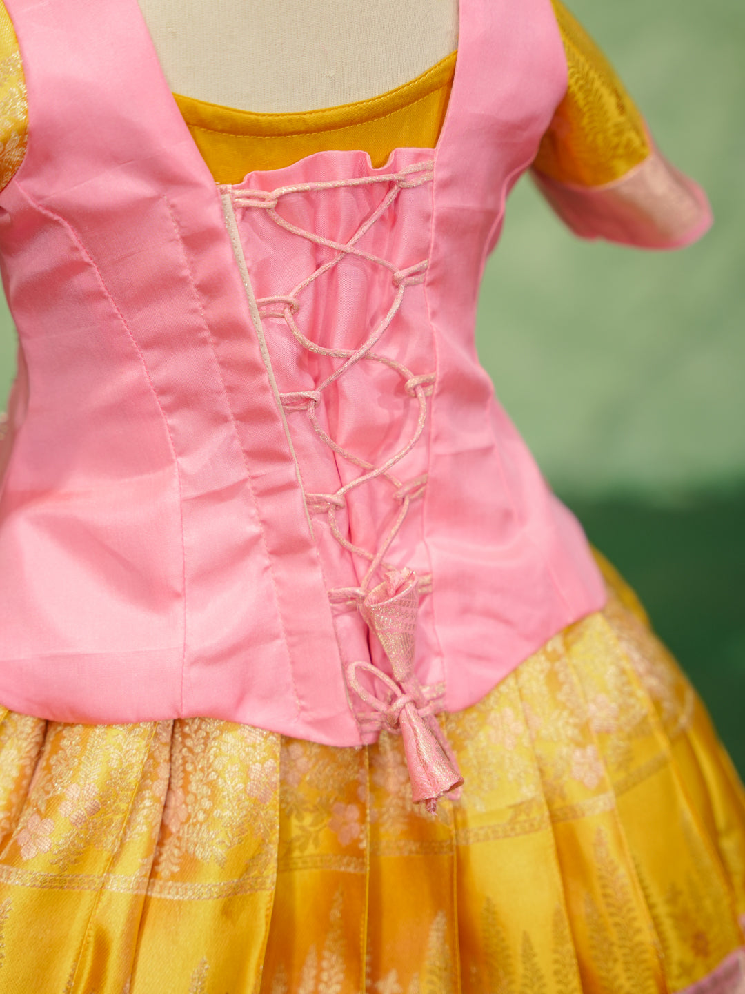 Pink and gold pattu pavadai in pure Kanchipuram silk with embellished blouse and zari skirt — back view