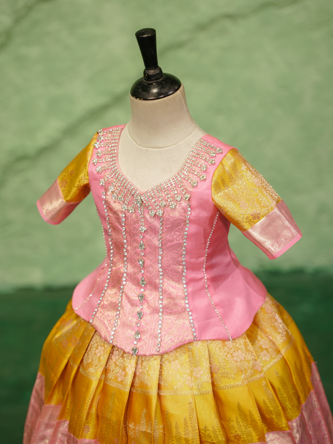 Pink and gold pattu pavadai in pure Kanchipuram silk with embellished blouse and zari skirt — neckline
