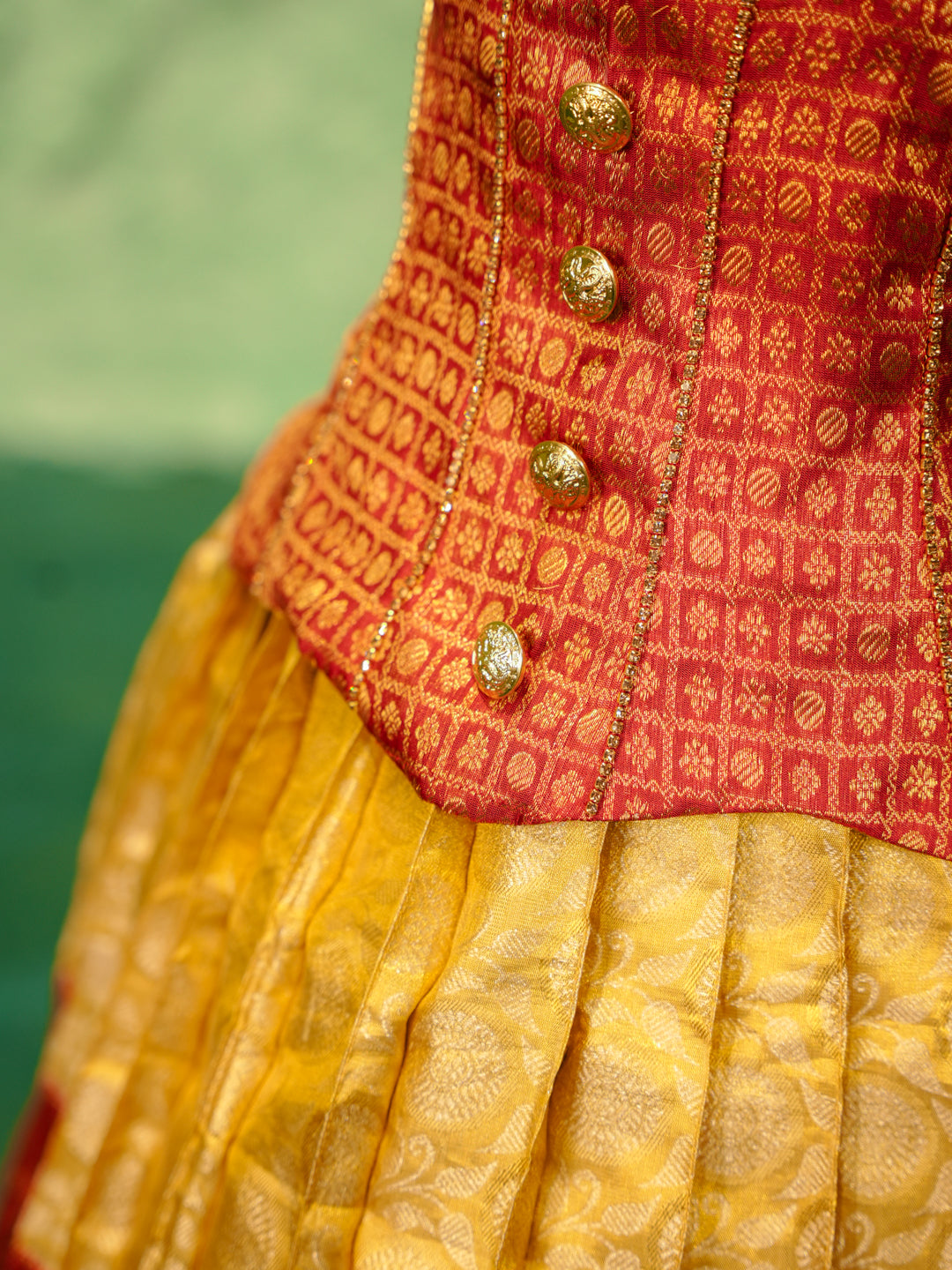 Red and yellow pattu pavadai in pure Kanchipuram silk with zari checks and puff sleeves — waist