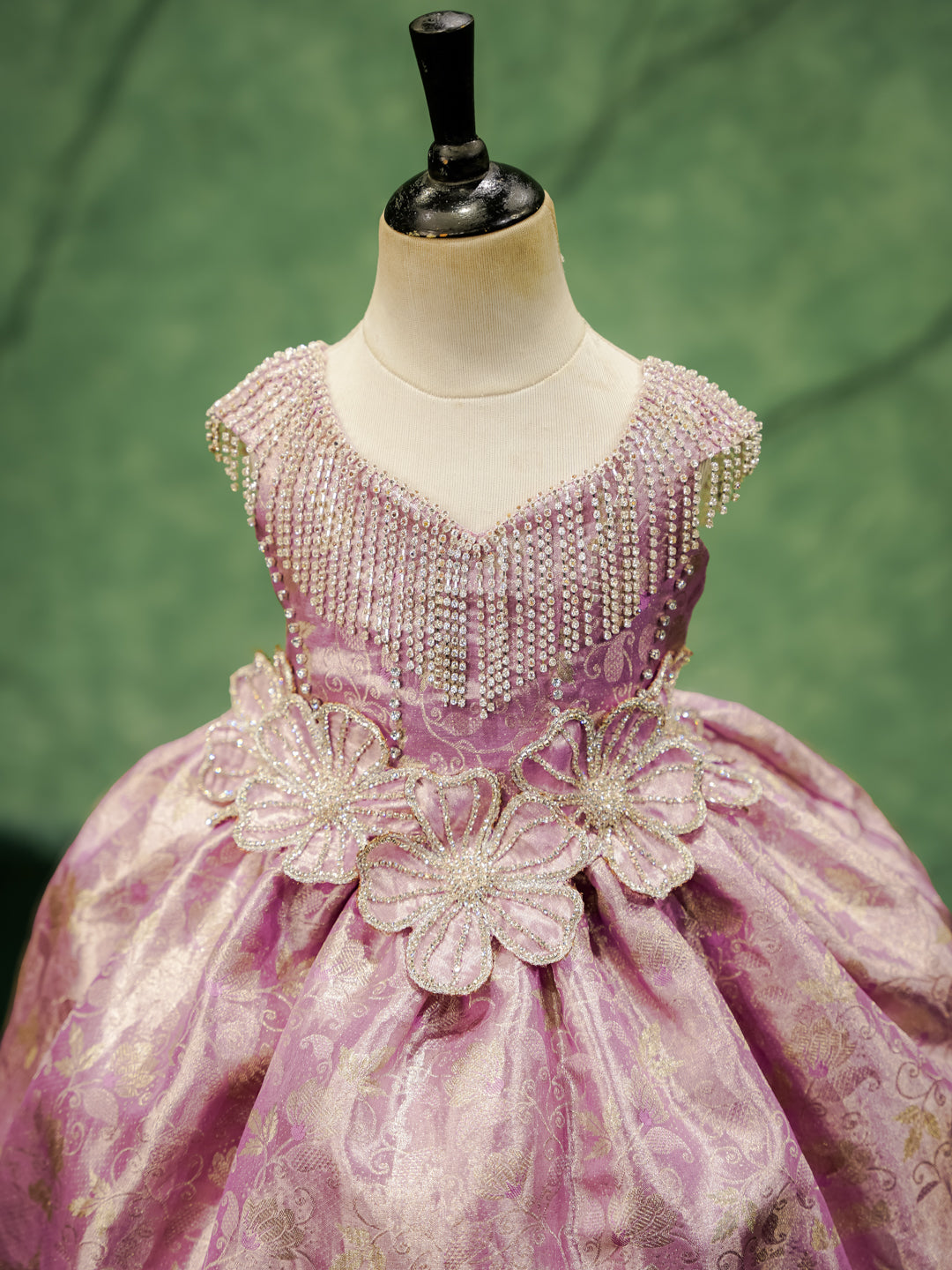 Close-up of the "Royal Orchid" gown's hand-beaded bodice with crystal fringe and 3D floral appliqués.
