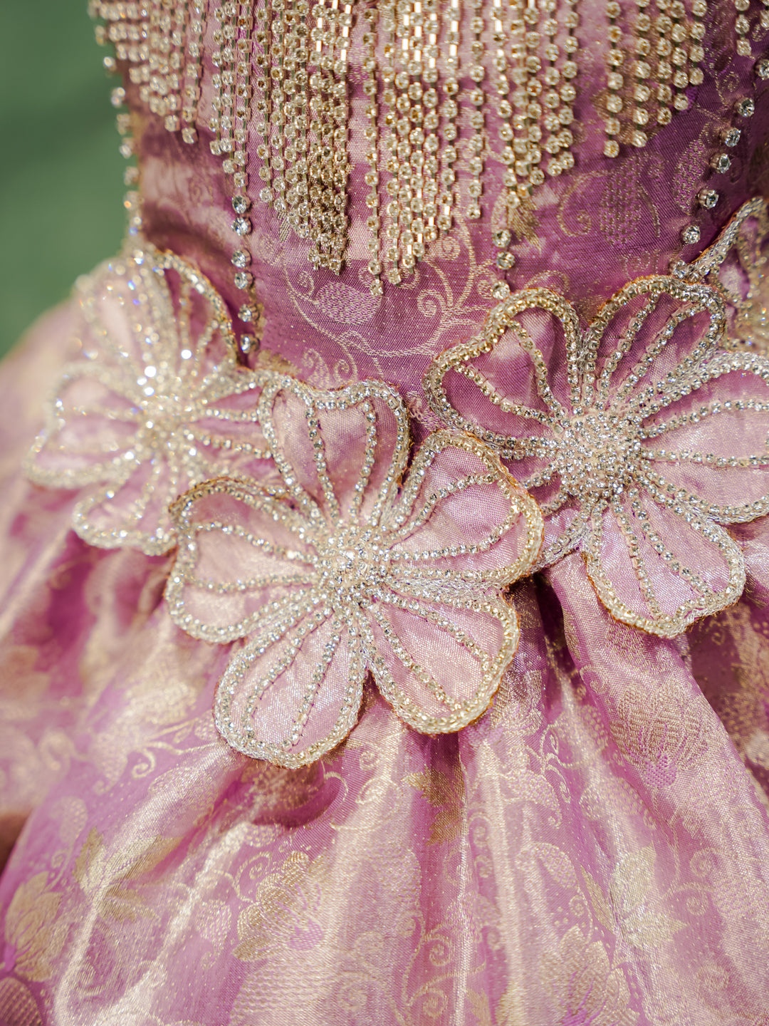 Close-up of the hand-beaded 3D floral appliqués on the waist of the "Royal Orchid" silk gown.