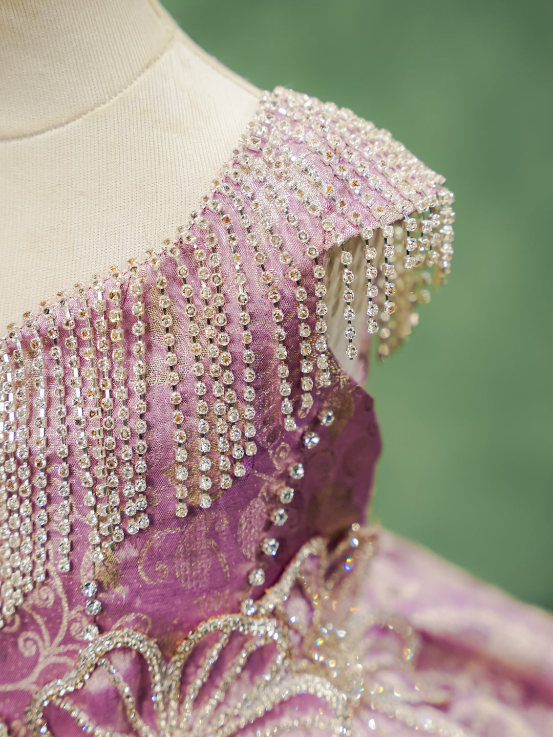 Detail of the draped crystal fringe and beading on the shoulder of a Kanchipuram silk dress.