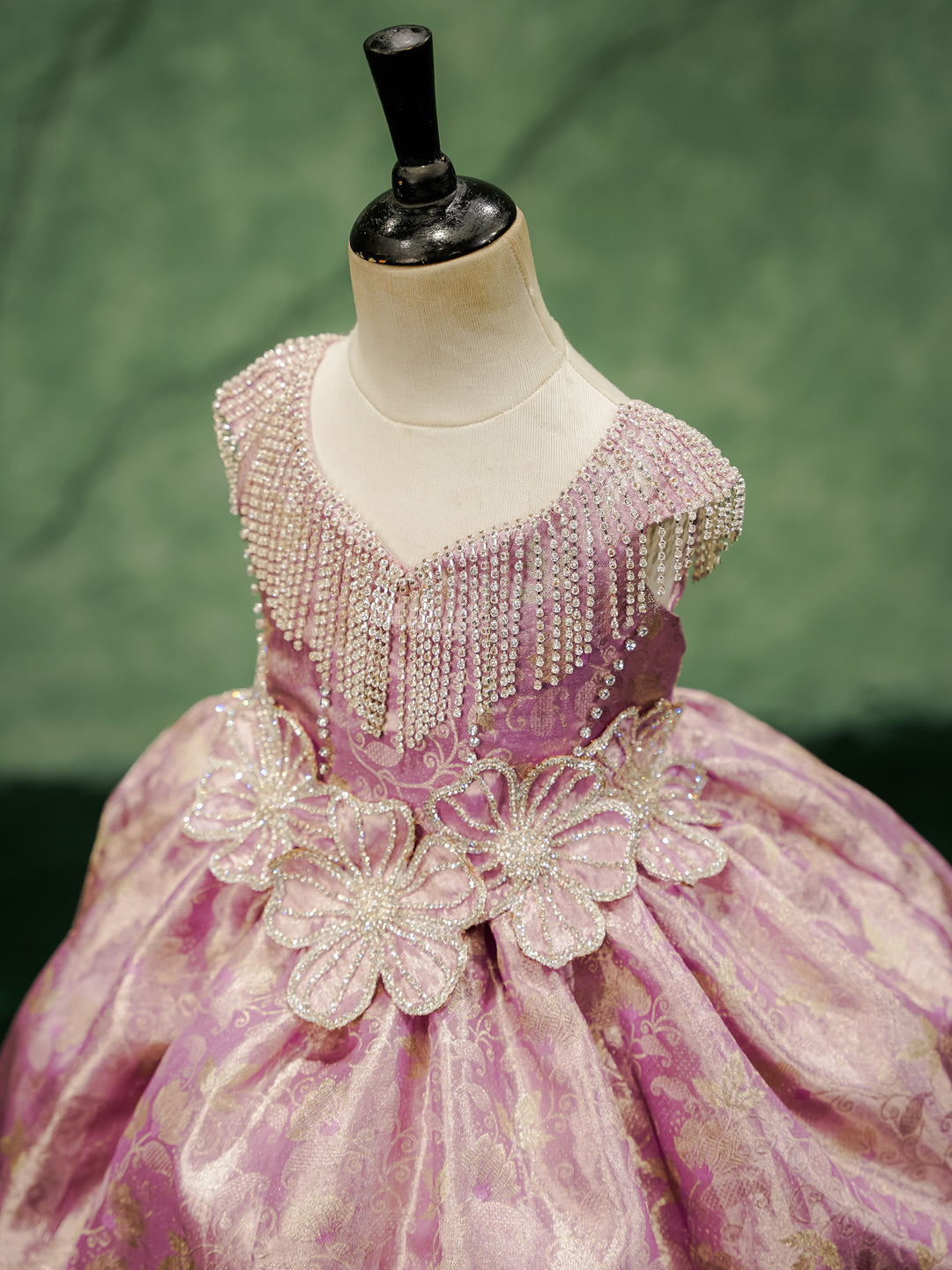 Close-up of the "Royal Orchid" gown's hand-beaded bodice with crystal fringe and 3D floral appliqués.