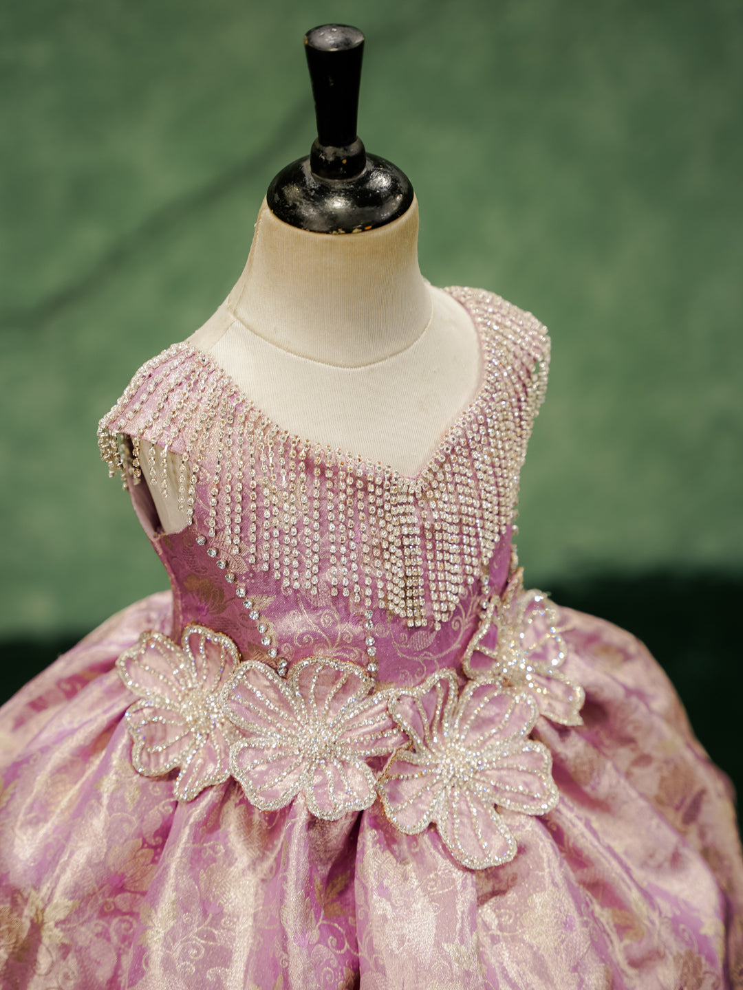Close-up of the "Royal Orchid" gown's hand-beaded bodice with crystal fringe and 3D floral appliqués.