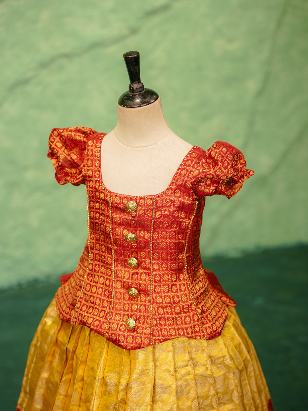 Red and yellow pattu pavadai in pure Kanchipuram silk with zari checks and puff sleeves — sleeve